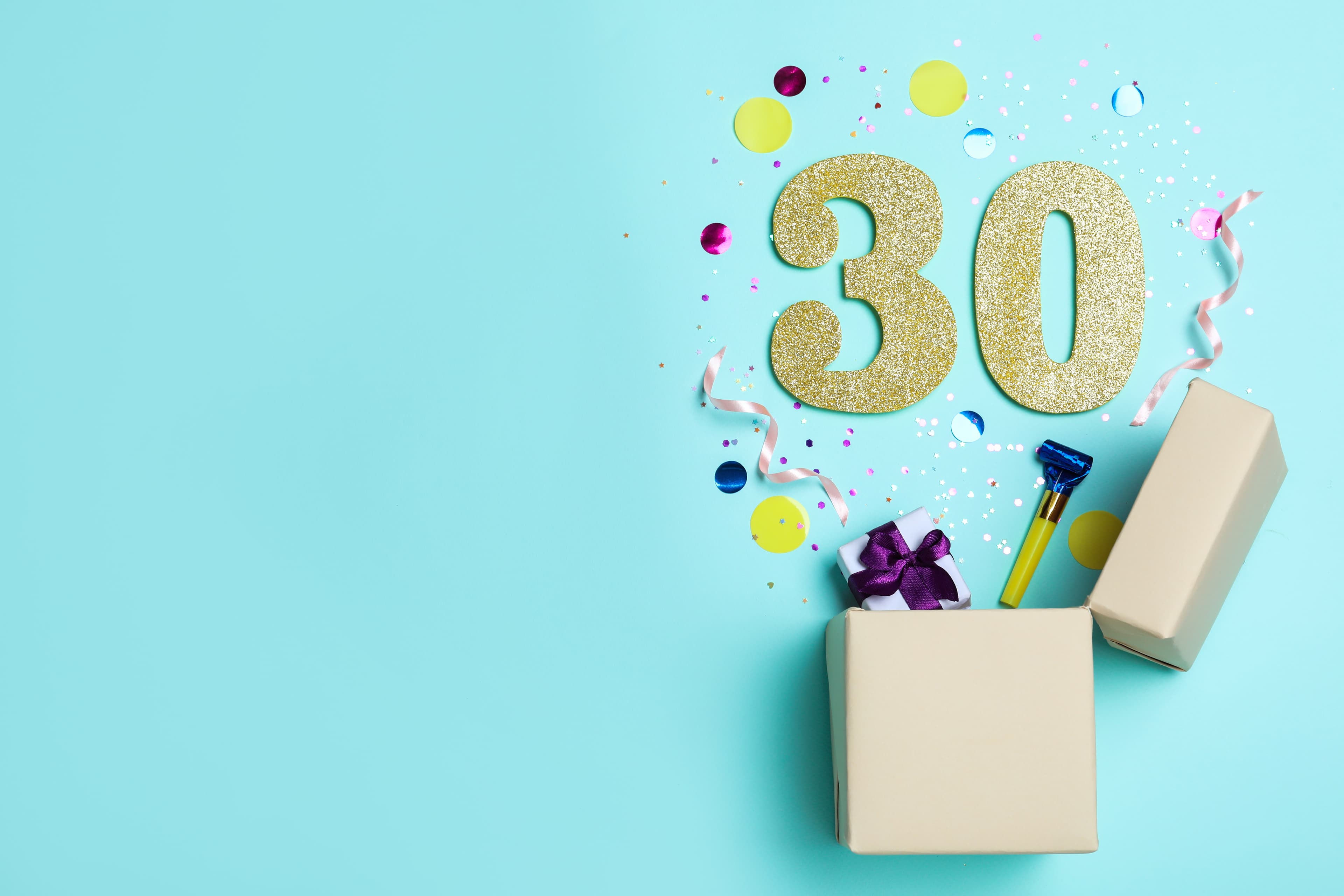 Flat lay composition with decor and numbers on light blue background, space for text. 30th birthday party