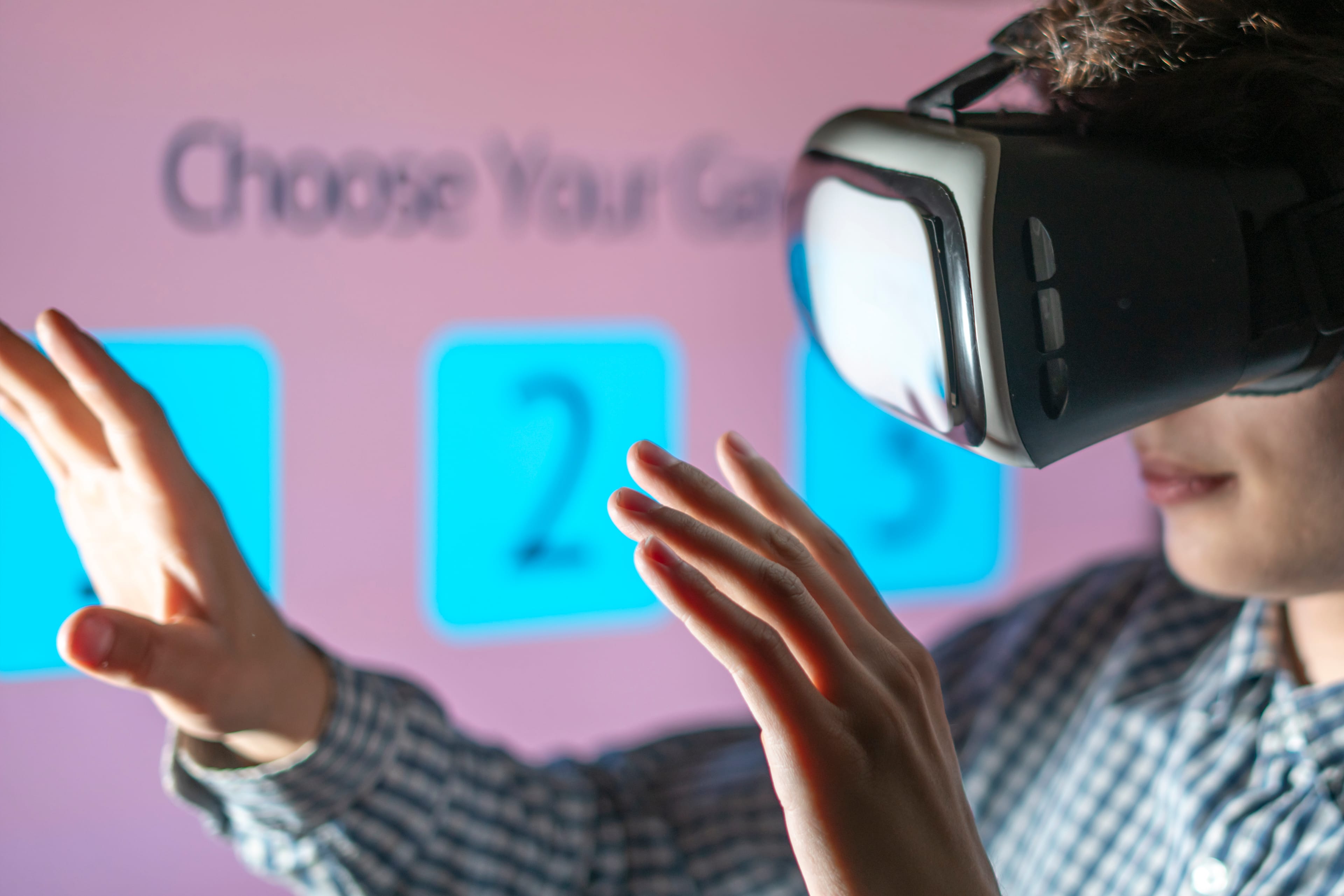 young man in vr glasses playing and choosing the game
