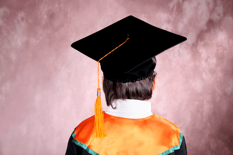 close up shot of boy in graduation out fit.